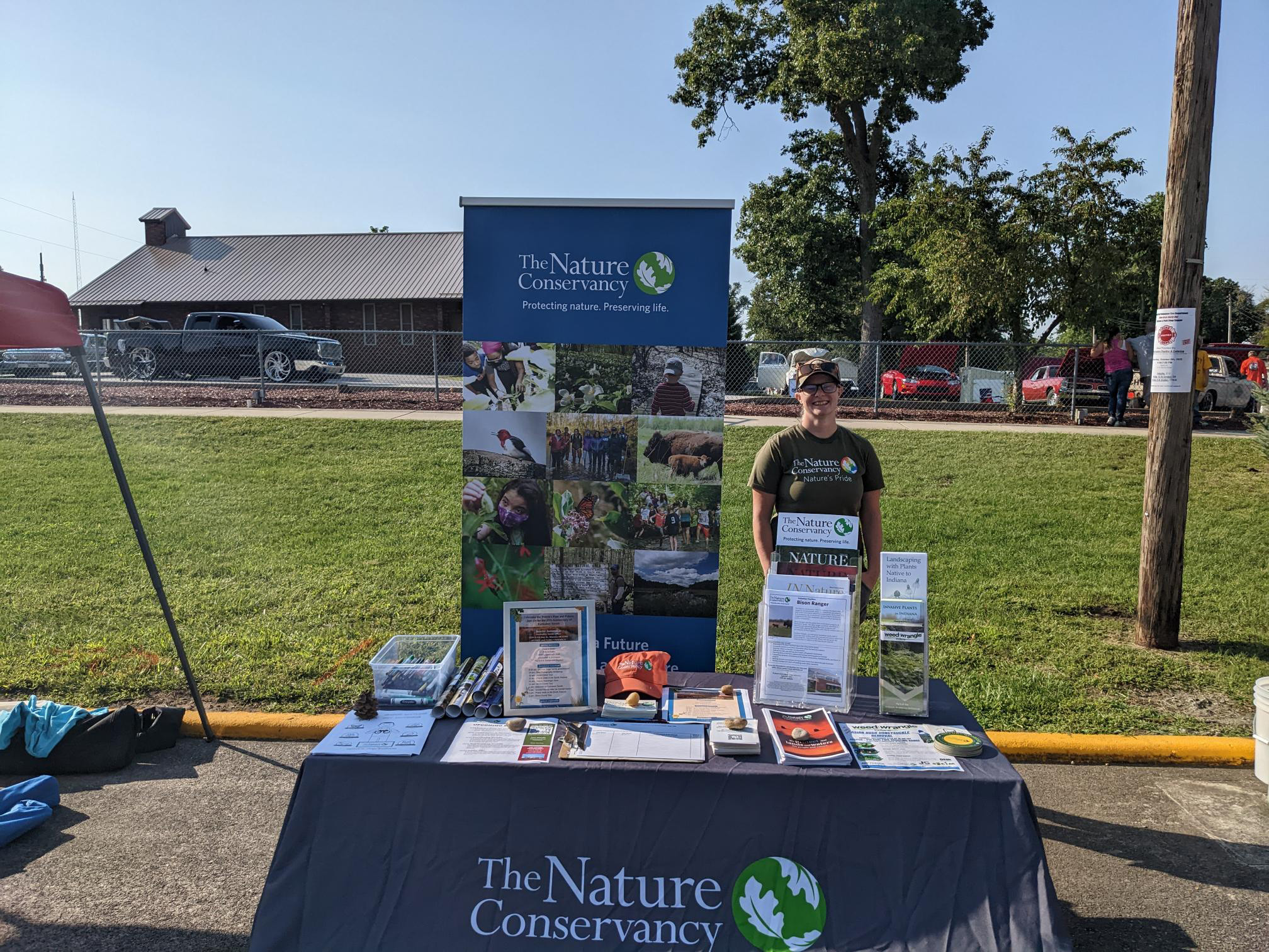 TNC's Katey Powell staffing a TNC booth at an outdoor event.