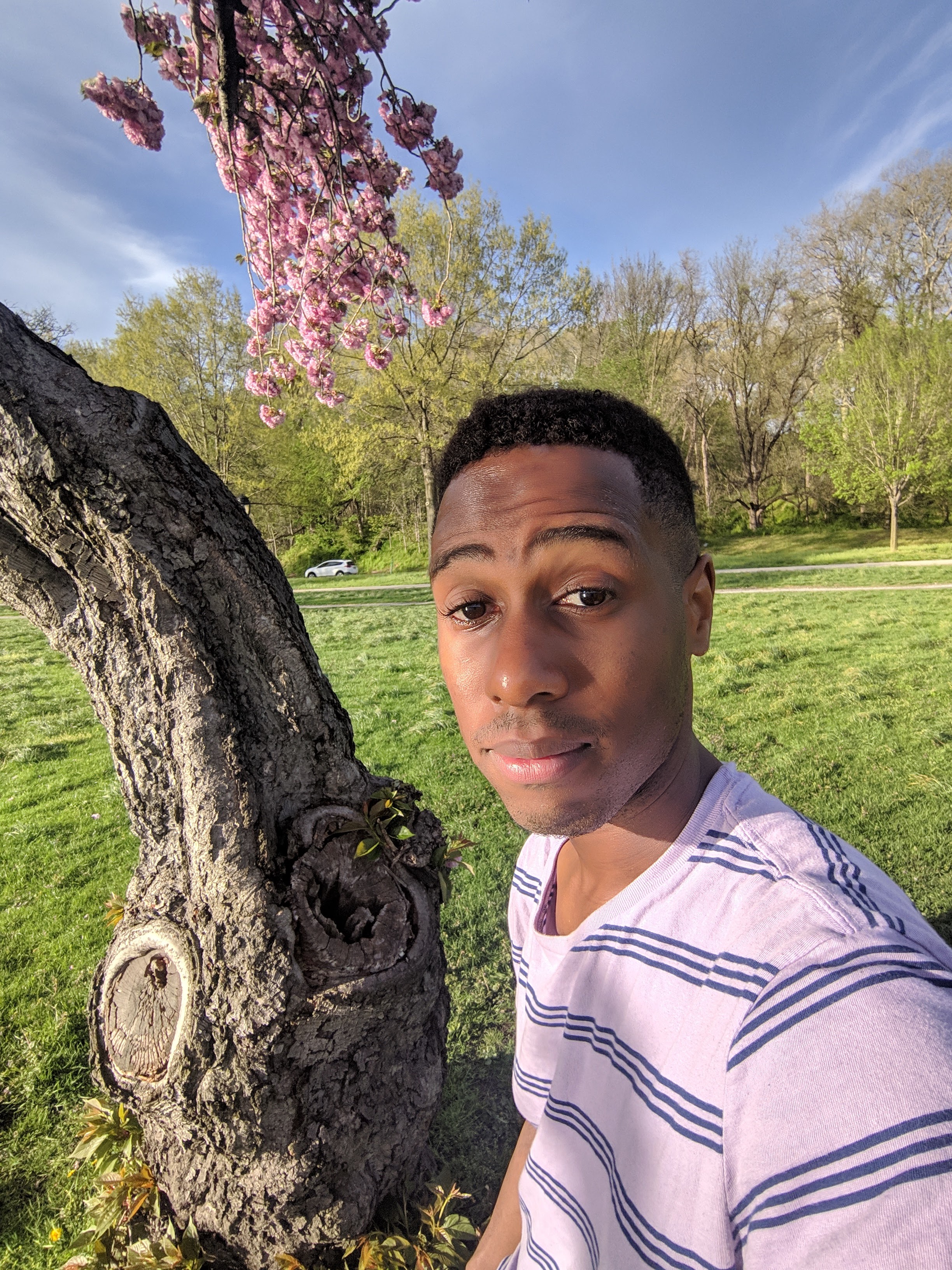 A selfie of Aaron Dandridge standing next to a tree.