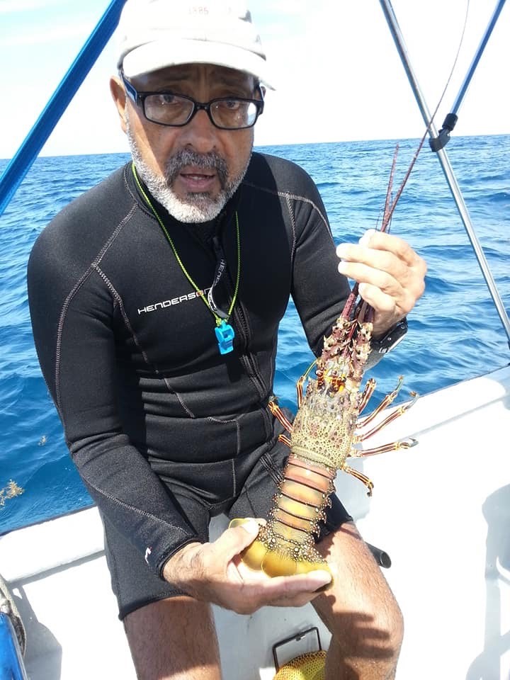 Diver holding a lobster.