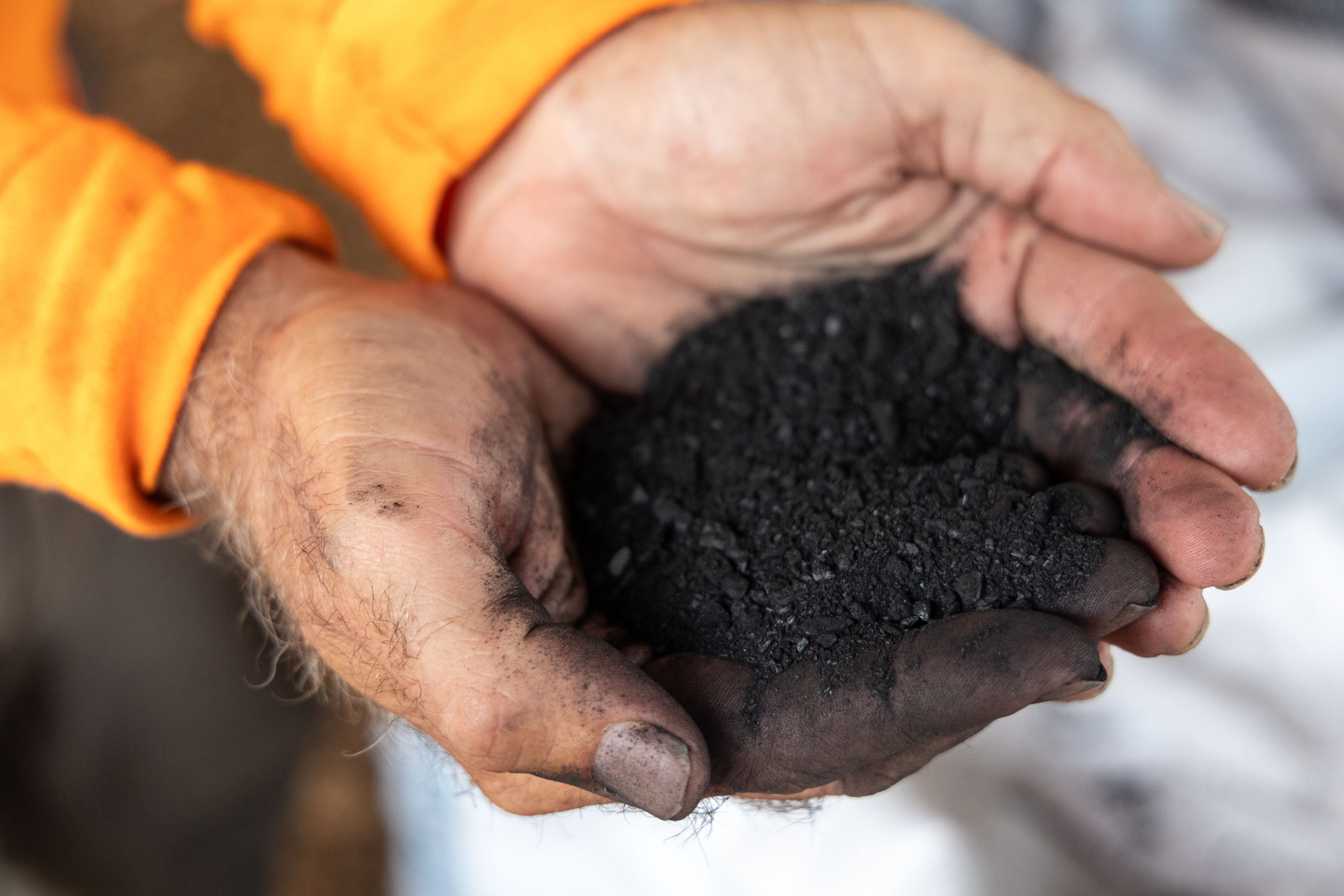 Joe Imhoff with a handful of biochar. 
