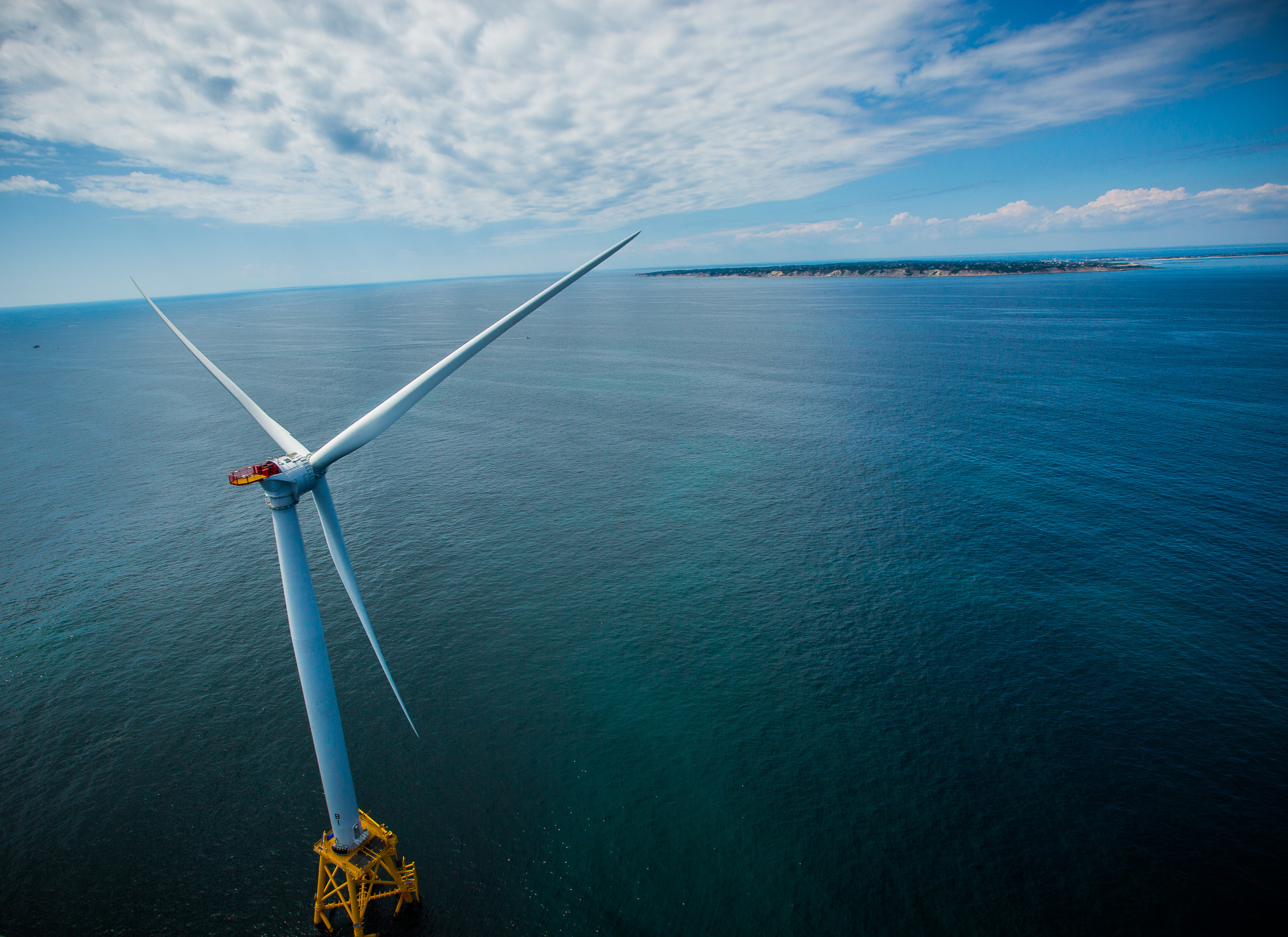 a large windmill in the ocean.