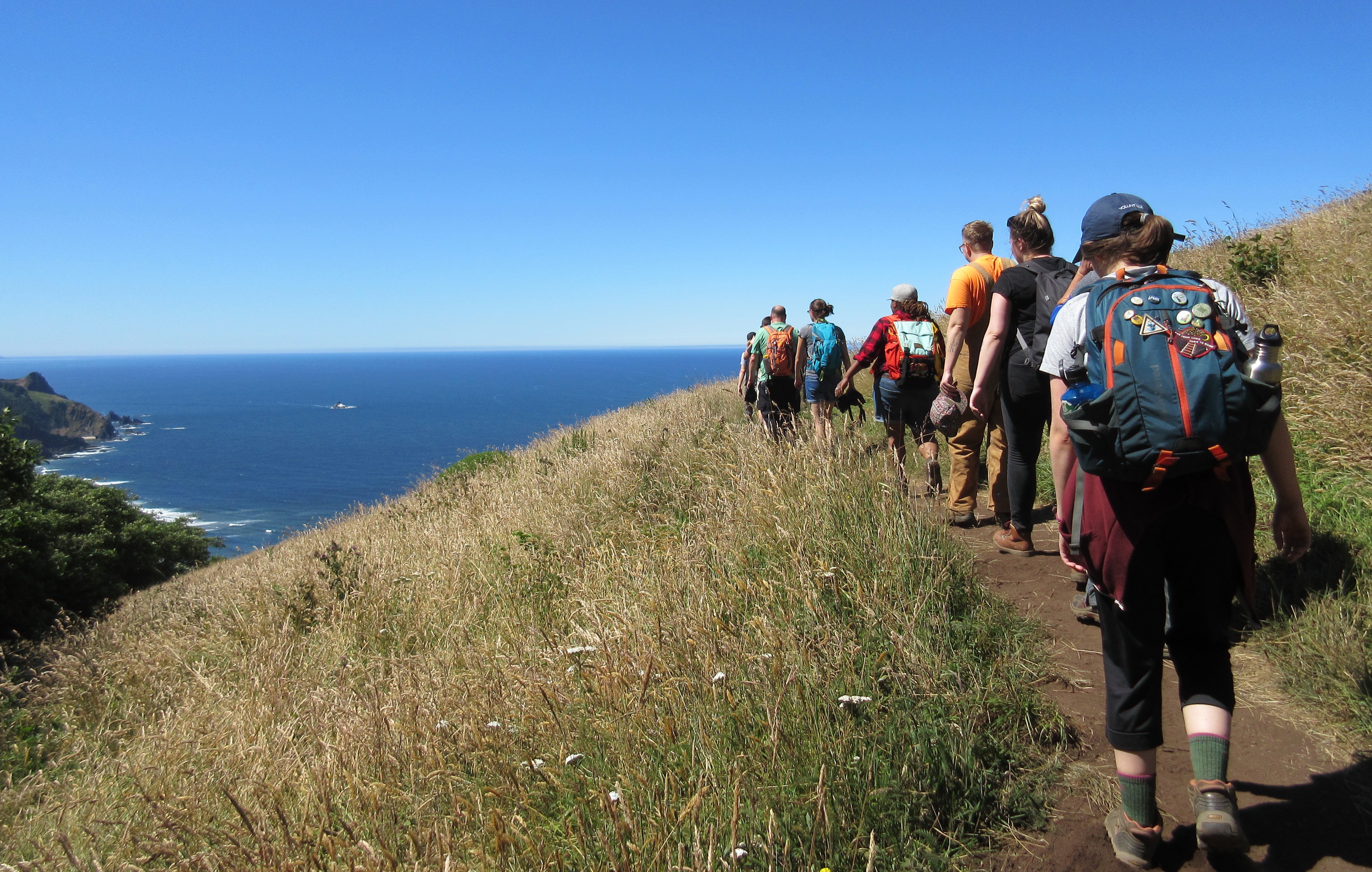 A group of people hiking on a trail.