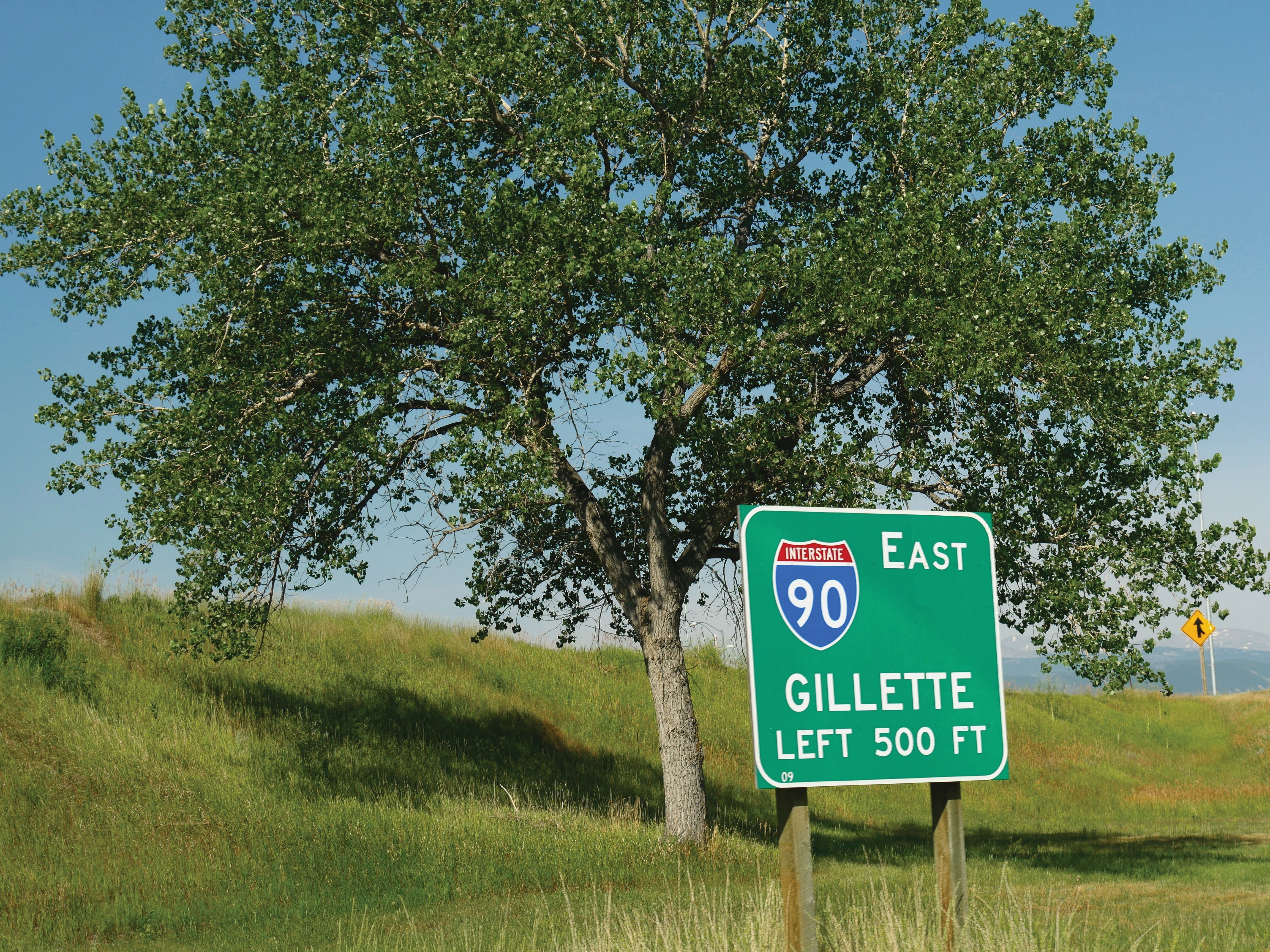 a highway sign for interstate 90 east. It says "Gillette left 500 ft".