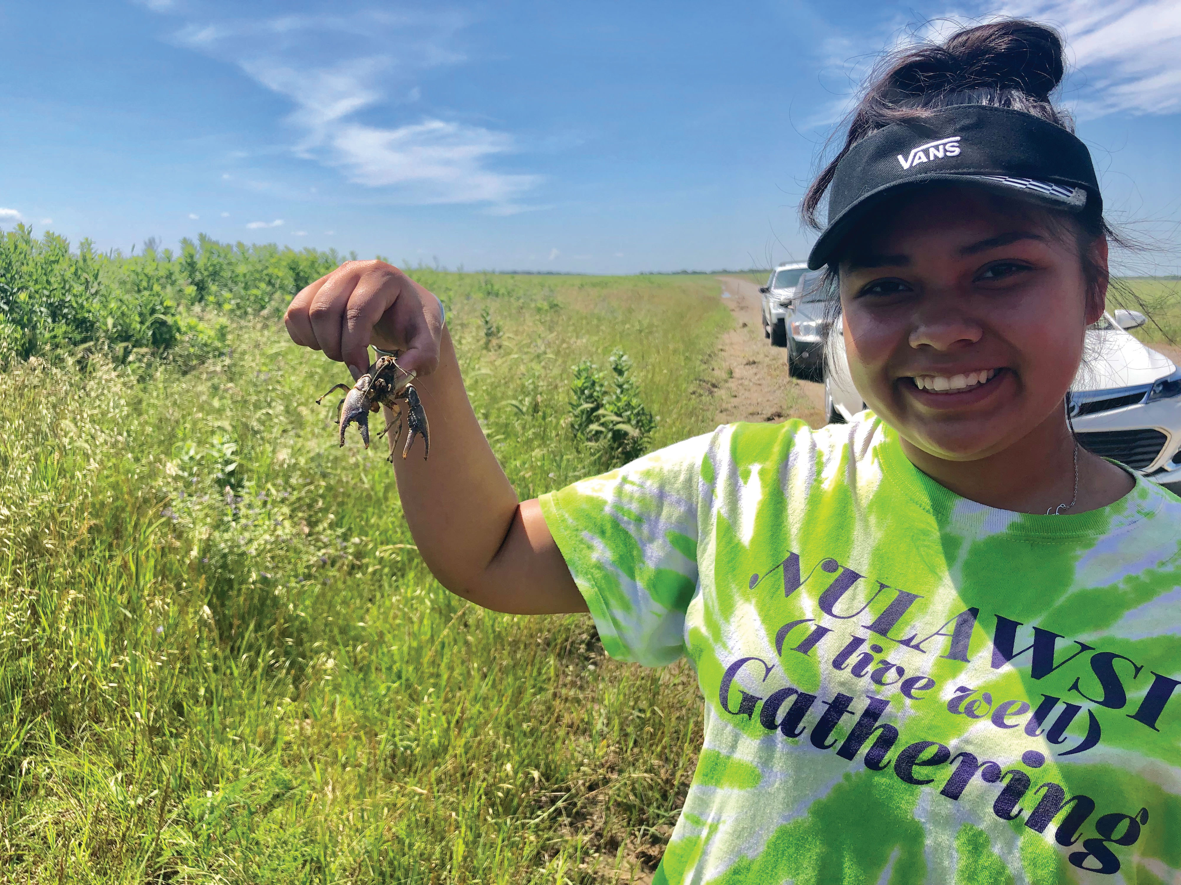 A volunteer holding onto a crawfish she spotted on the preserve. 