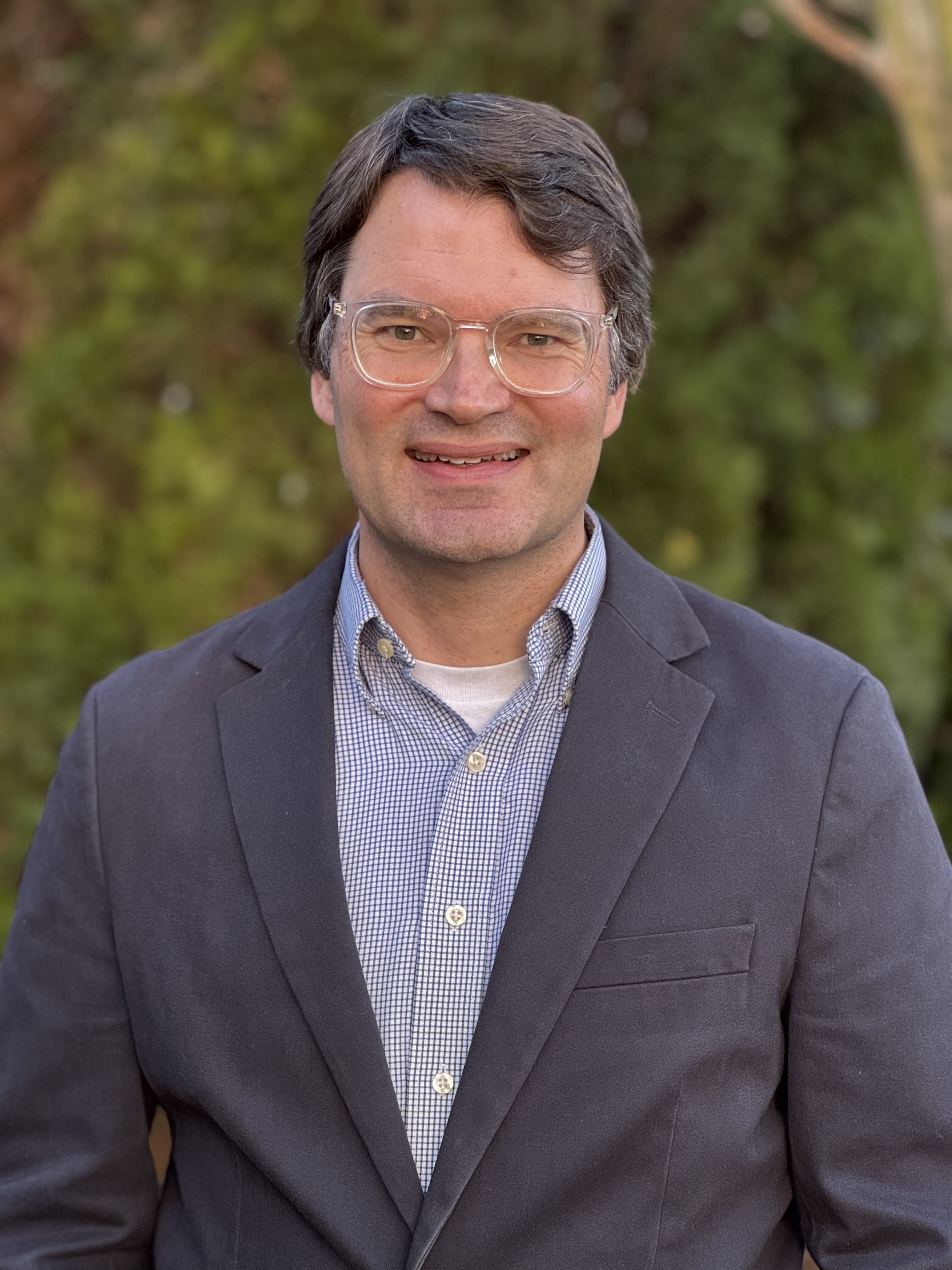 A headshot of Greg Patterson outdoors.