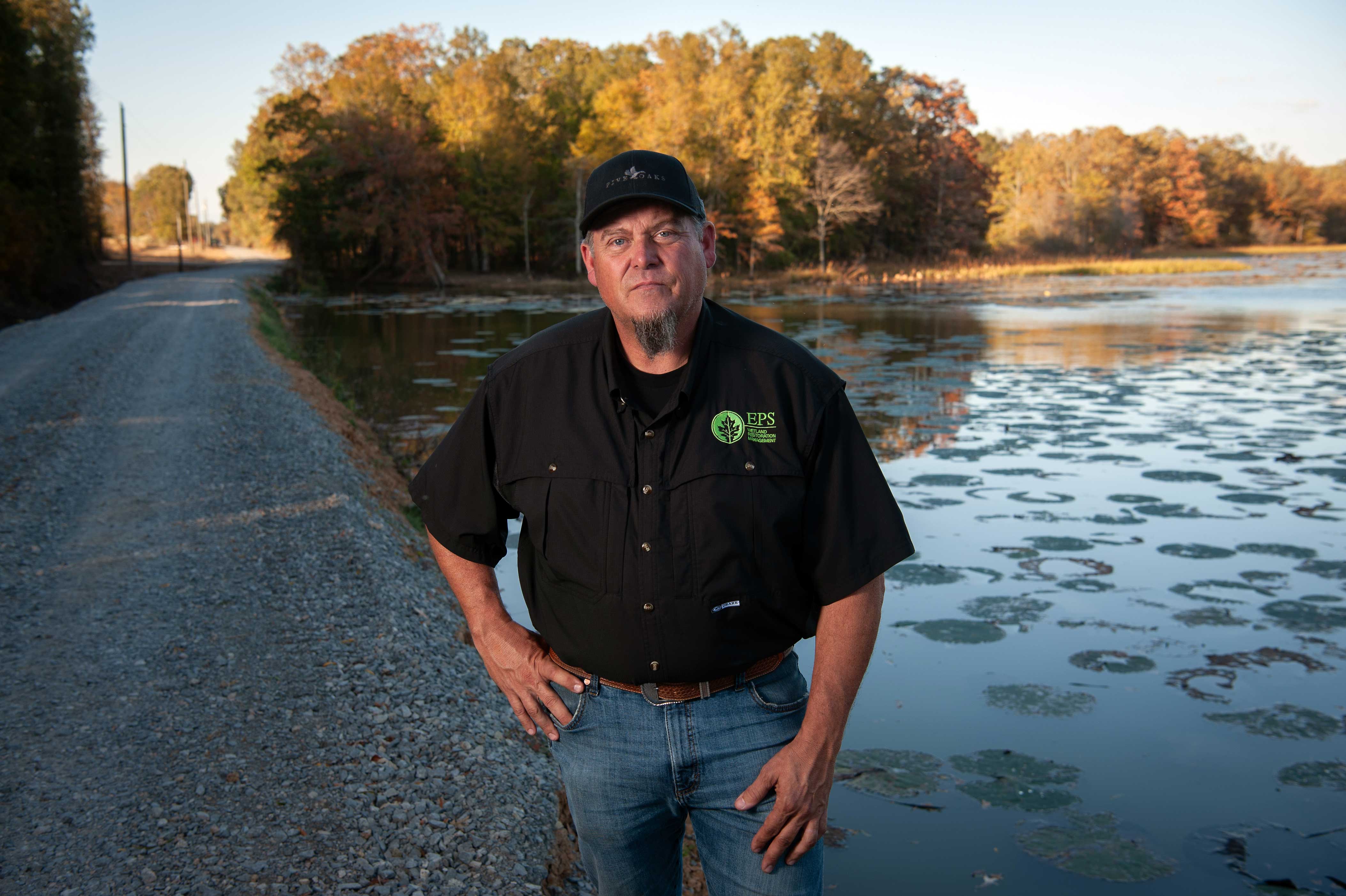 Wetland biologist Jody Pagan standing in front of a marsh.