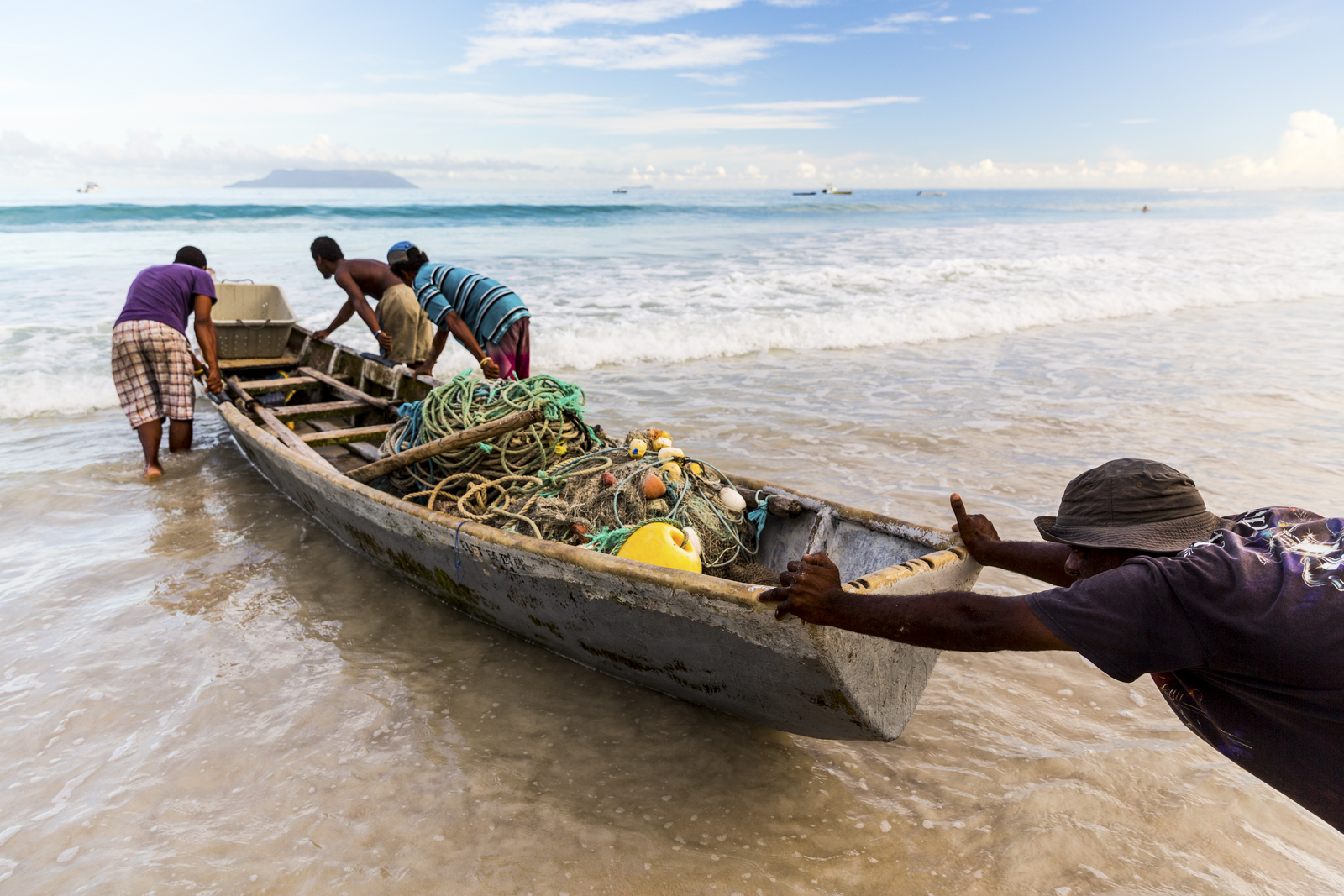 Mackerel fishermen launch their small boat.